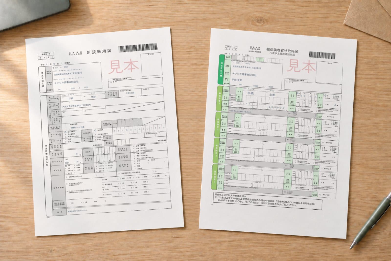 印刷した新規適用届と被保険者資格取得届(見本データ)が机に並んでいる
